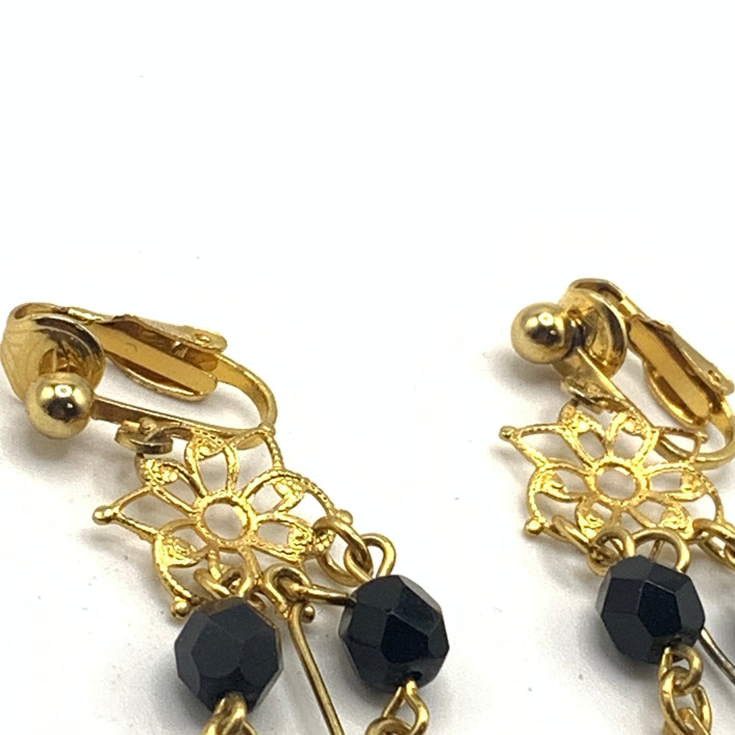 Vintage unsigned gold tone filigree black beaded dangle clip on earrings
