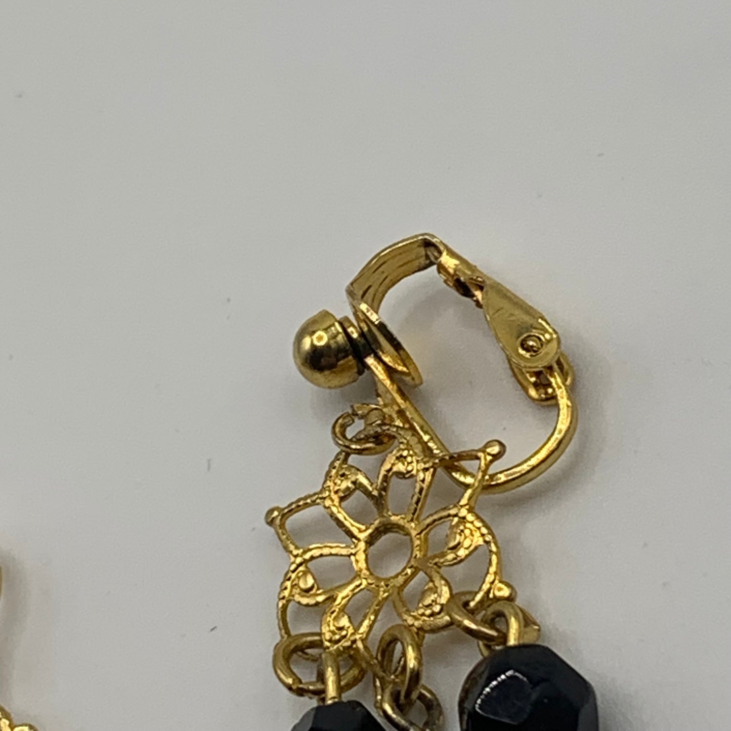 Vintage unsigned gold tone filigree black beaded dangle clip on earrings