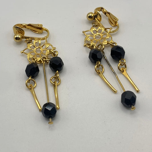 Vintage unsigned gold tone filigree black beaded dangle clip on earrings